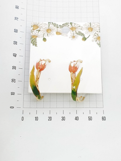 Size reference photo of handmade tulip hoop earrings with measuring tape