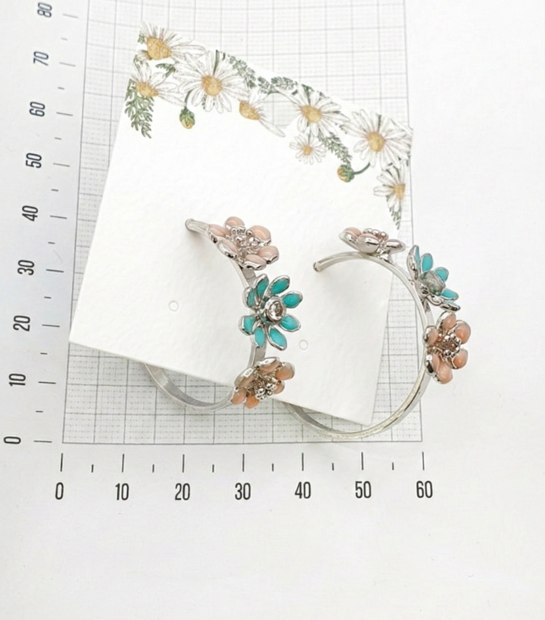 size reference of mint garden enamel flower hoop earrings with measuring ruler showing 2.5-3cm diameter