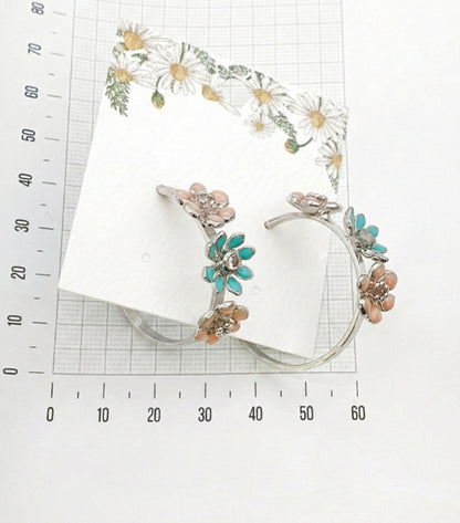 size reference of mint garden enamel flower hoop earrings with measuring ruler showing 2.5-3cm diameter