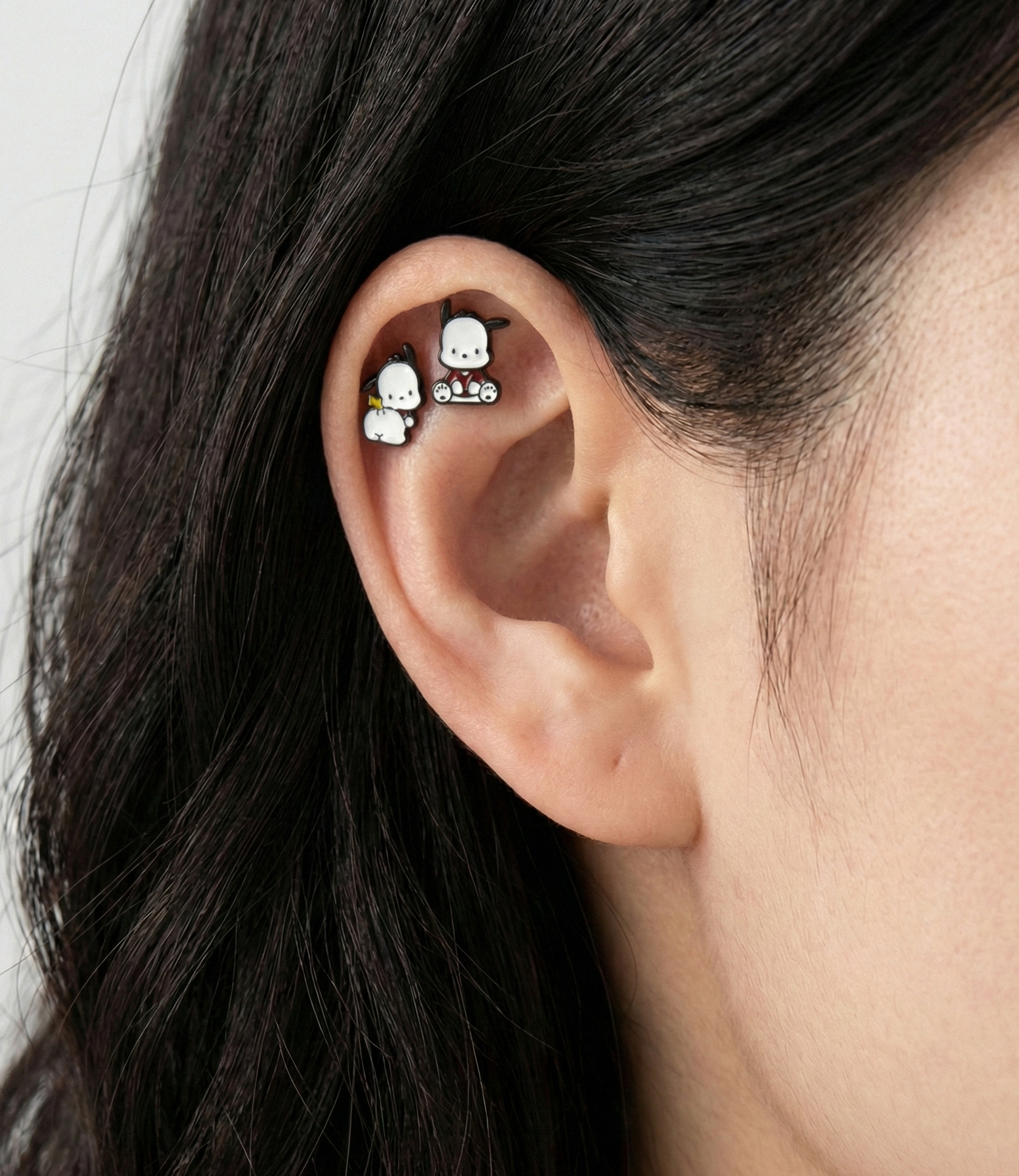 Two Pochacco barbell studs in sitting and back view styles worn on ear cartilage