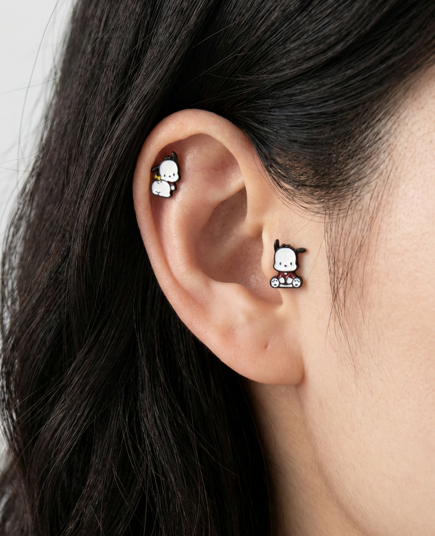 Two Pochacco barbell studs in sitting and back view styles worn on ear cartilage