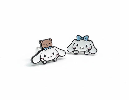 Flat lay comparison of left puppy bear and right puppy bow asymmetric earring designs