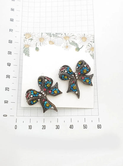 Silver Blue crystal bow stud earrings on floral jewelry card with ruler for size reference — approx. 3.2cm wide, handmade in Korea