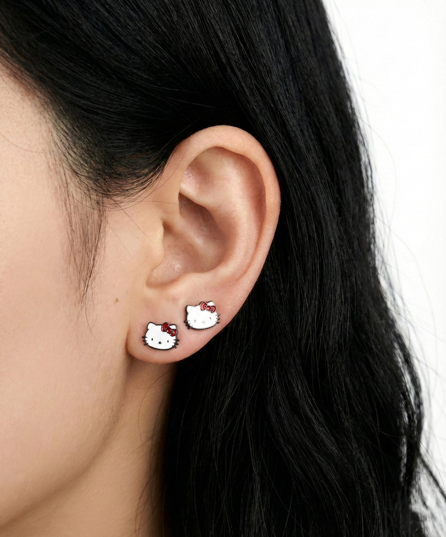 Hello Kitty classic barbell stud earrings worn in both lobe piercings