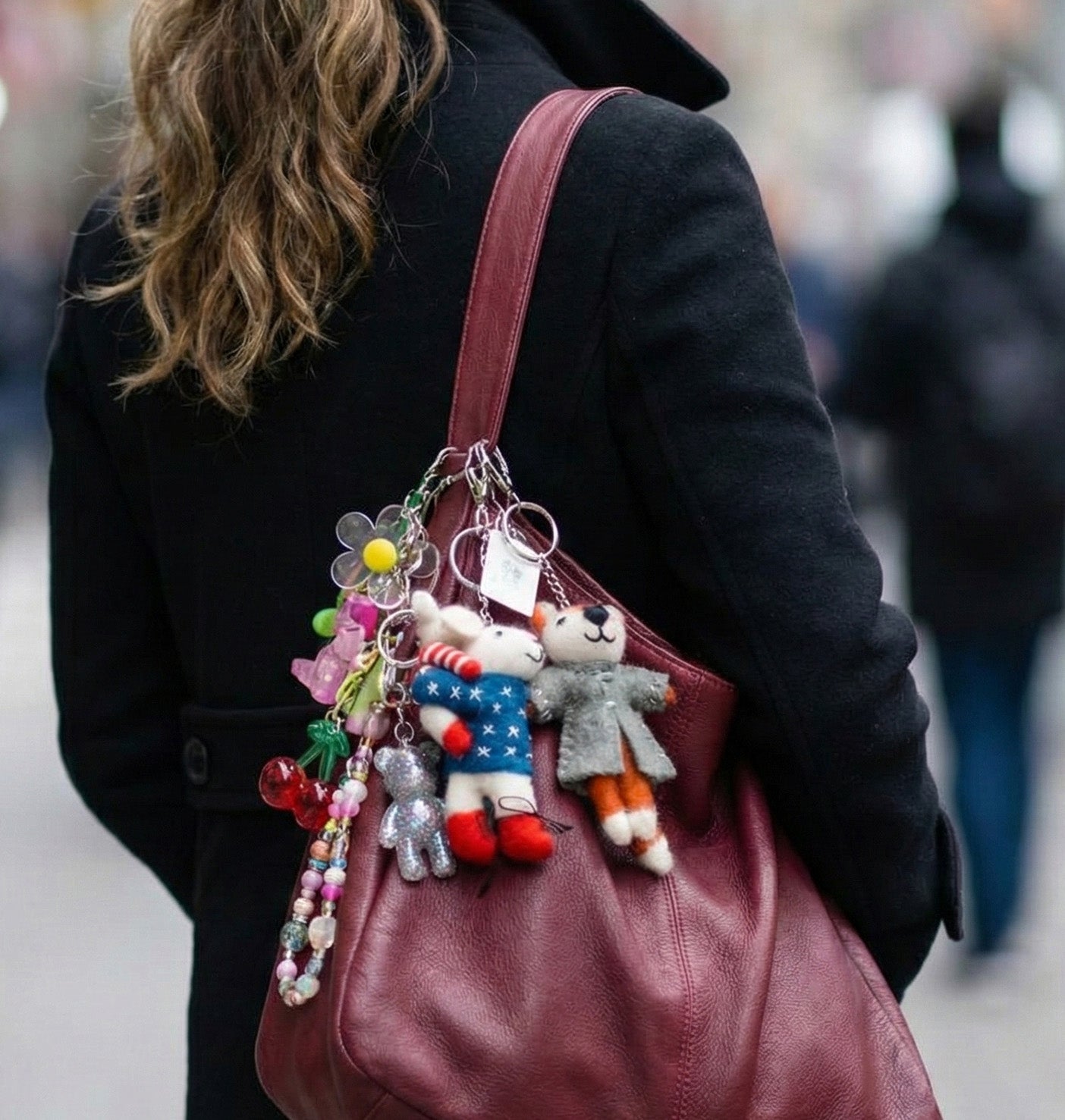 Burgundy bag with wool felt animal keychains and colorful charms street style