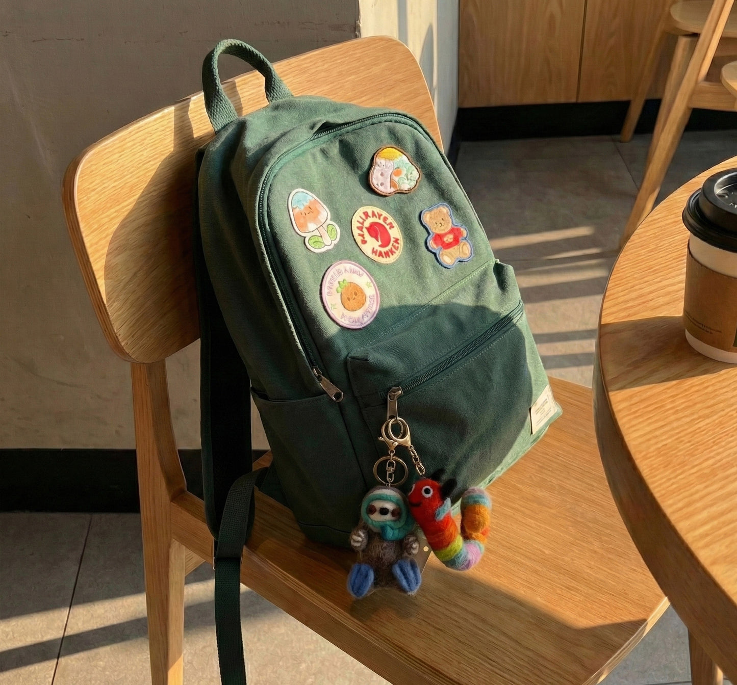 Student backpack decorated with multiple Nepal wool felt animal keychains