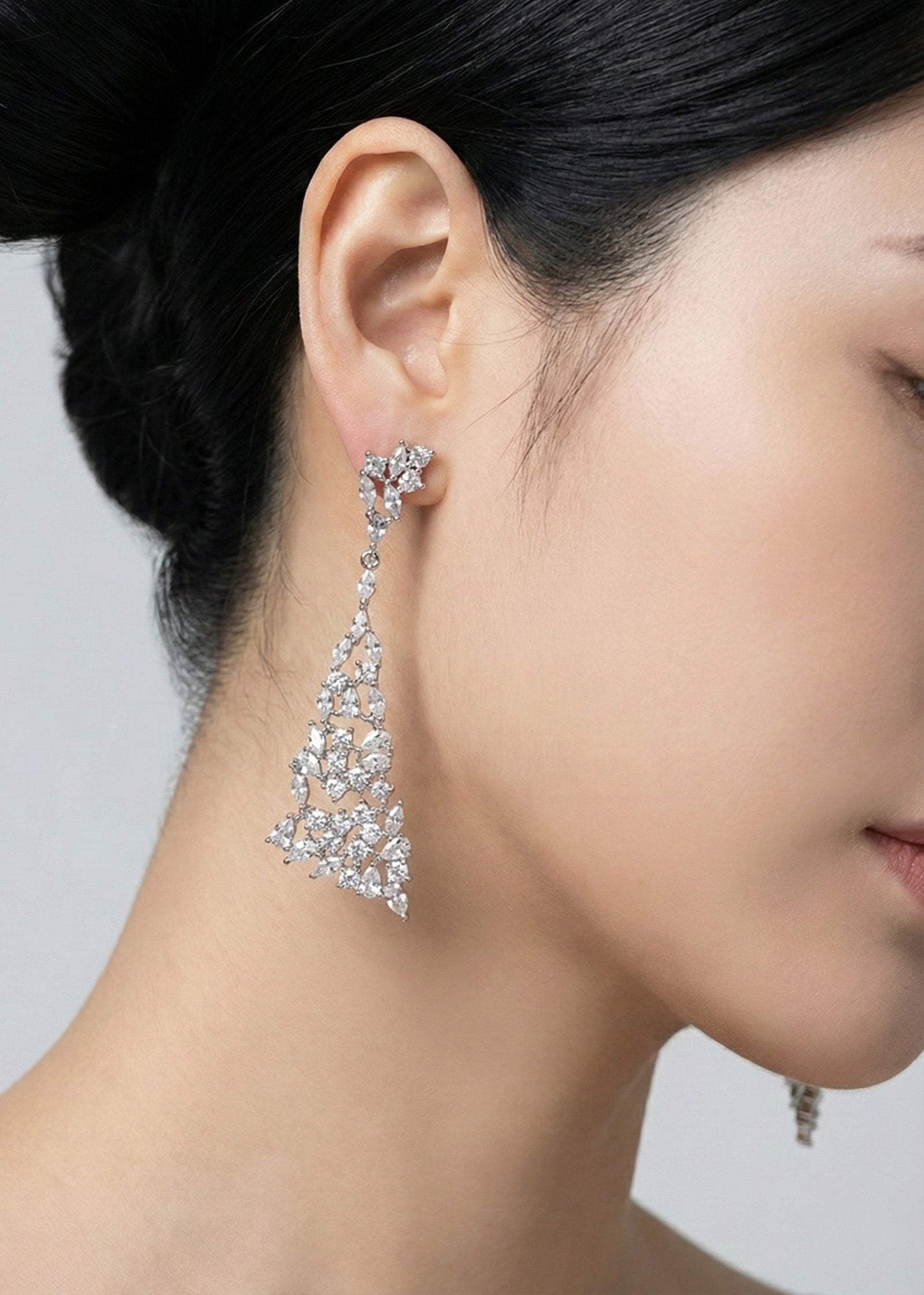 Side view of rose gold CZ chandelier earrings showing intricate lace pattern
