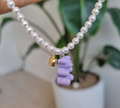  Close-up of lavender purple gummy bear charm on Swarovski pearl necklace with gold accent bead