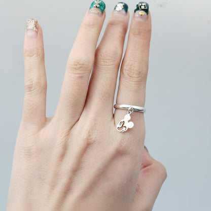 Solid silver Mickey charm ring on middle finger with decorative nail art, showing premium quality jewelry styling