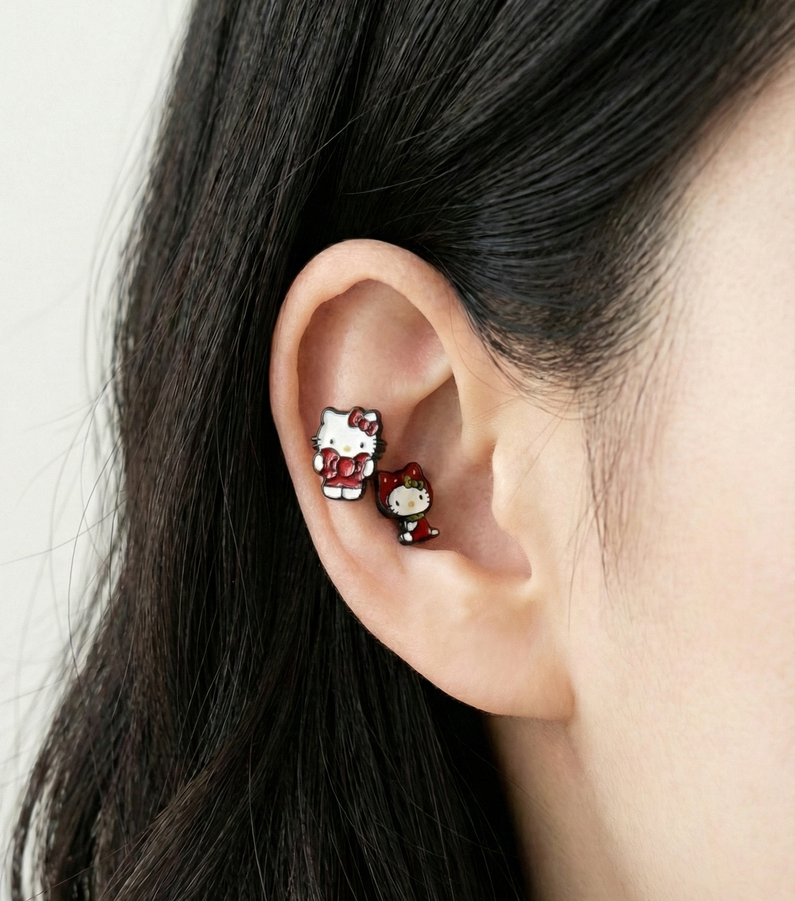  Hello Kitty piercing studs worn in inner conch showing layered cartilage styling