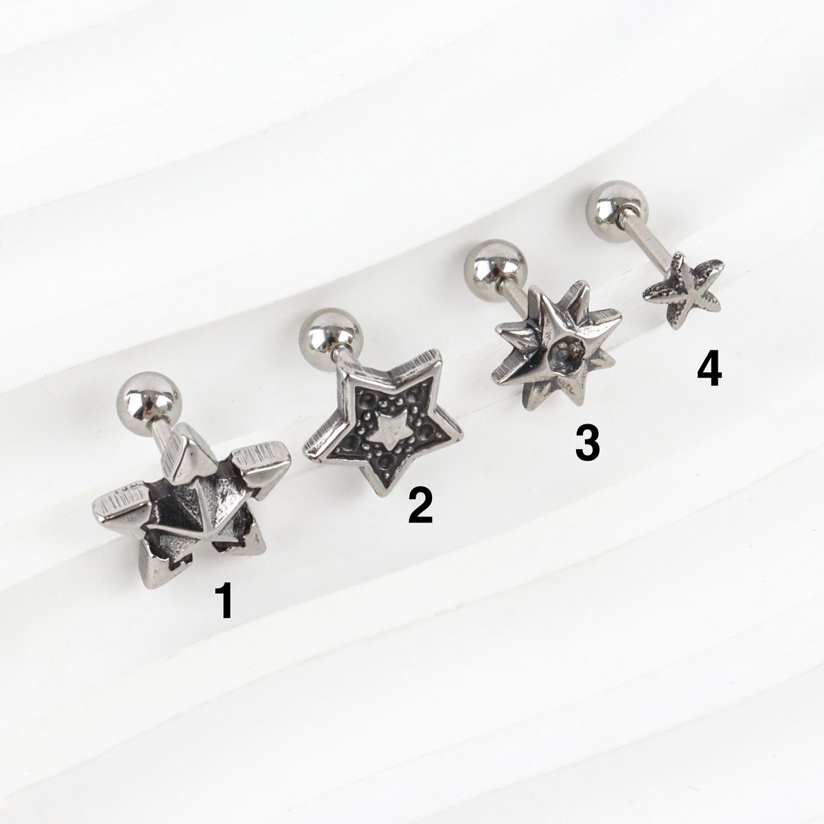 Four Y2K chunky star barbell stud earrings labeled 1 to 4, showing different sizes and designs on white background