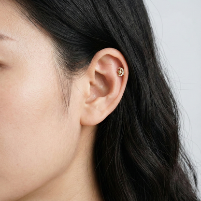 Woman wearing crescent moon star piercing on helix cartilage, minimalist ear styling