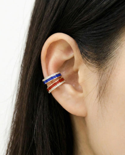 Triple-layer ear cuff with red enamel, blue enamel, and cubic zirconia rows, worn on upper ear