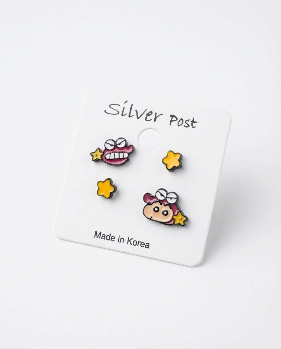 Close-up of Shin-chan Chocobi enamel stud earrings set with 925 silver posts on white backing card, Made in Korea label visible
