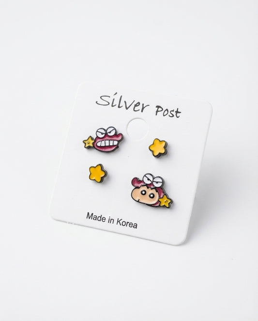 Close-up of Shin-chan Chocobi enamel stud earrings set with 925 silver posts on white backing card, Made in Korea label visible