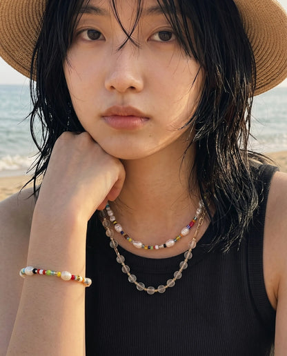 Downtown girl aesthetic — 8ttitto8 freshwater pearl Miyuki bead choker necklace worn with bead bracelet, shagy cut hair K-fashion inspo