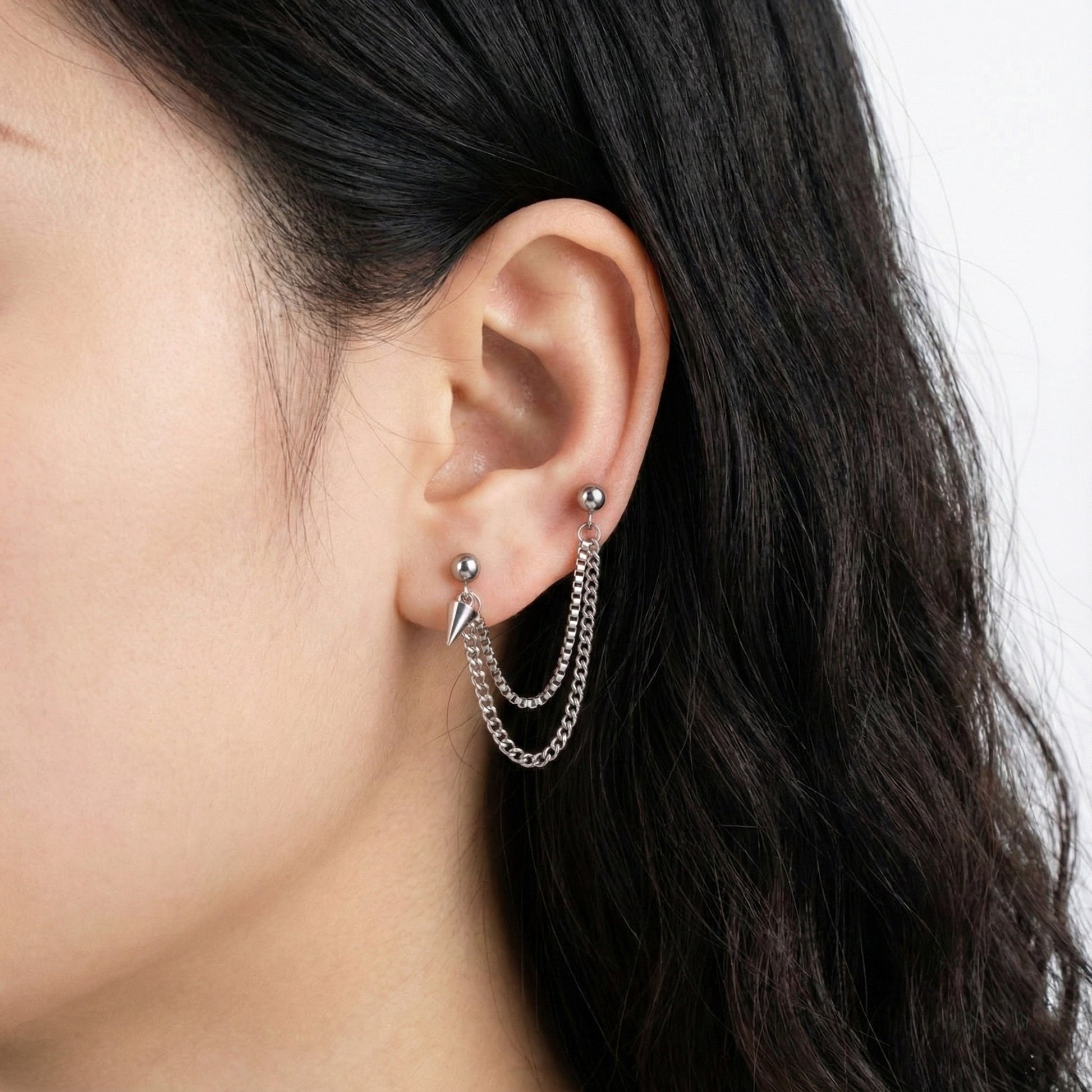 Side view of surgical steel chain piercing with dual texture chains  