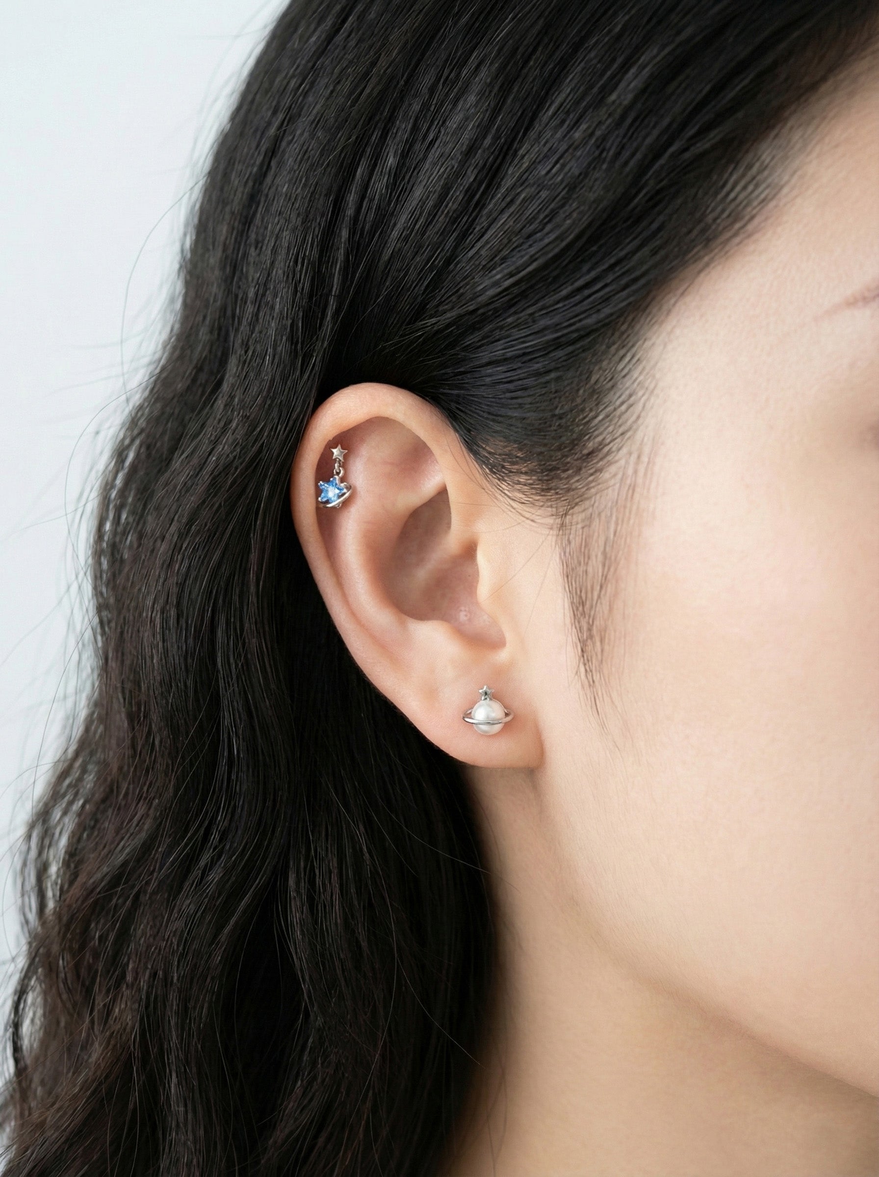 Celestial ear styling with Saturn planet piercing on helix and star stud on lobe in surgical steel"