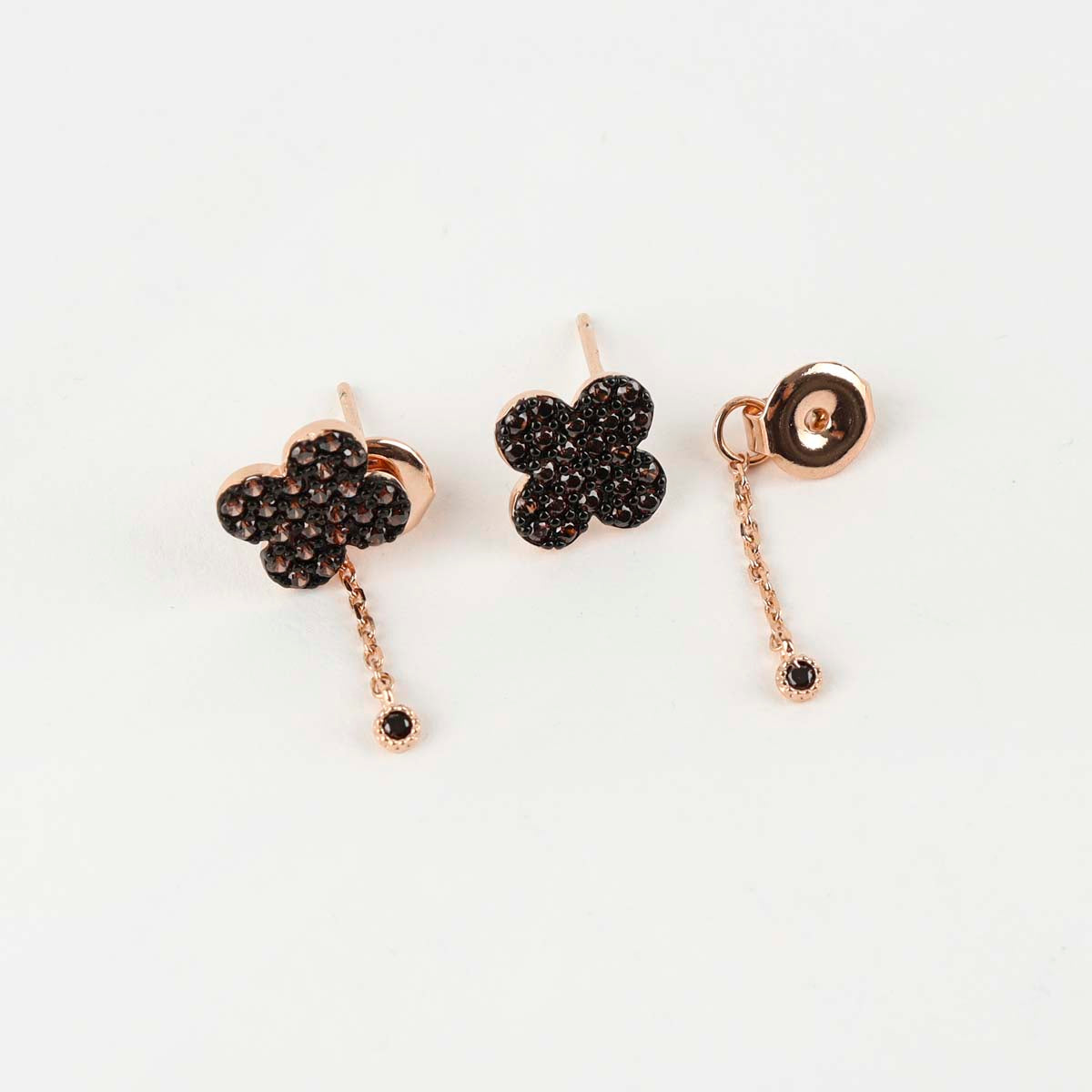 Three-piece layout showing clover stud front, chain ear jacket back, and assembled two-way drop earring in cognac CZ and rose gold