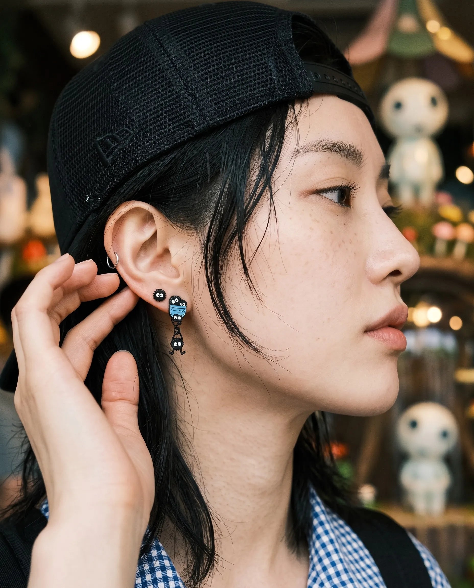 Kitsch-coded soot sprite stud earrings, hypoallergenic surgical steel post for daily wear.
