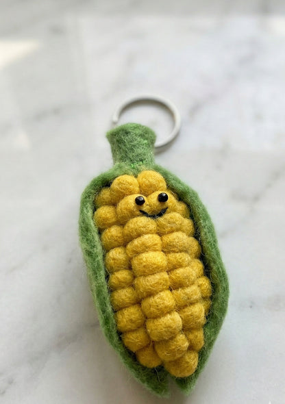 Cute corn keychain close-up - detailed textured kernels with smile