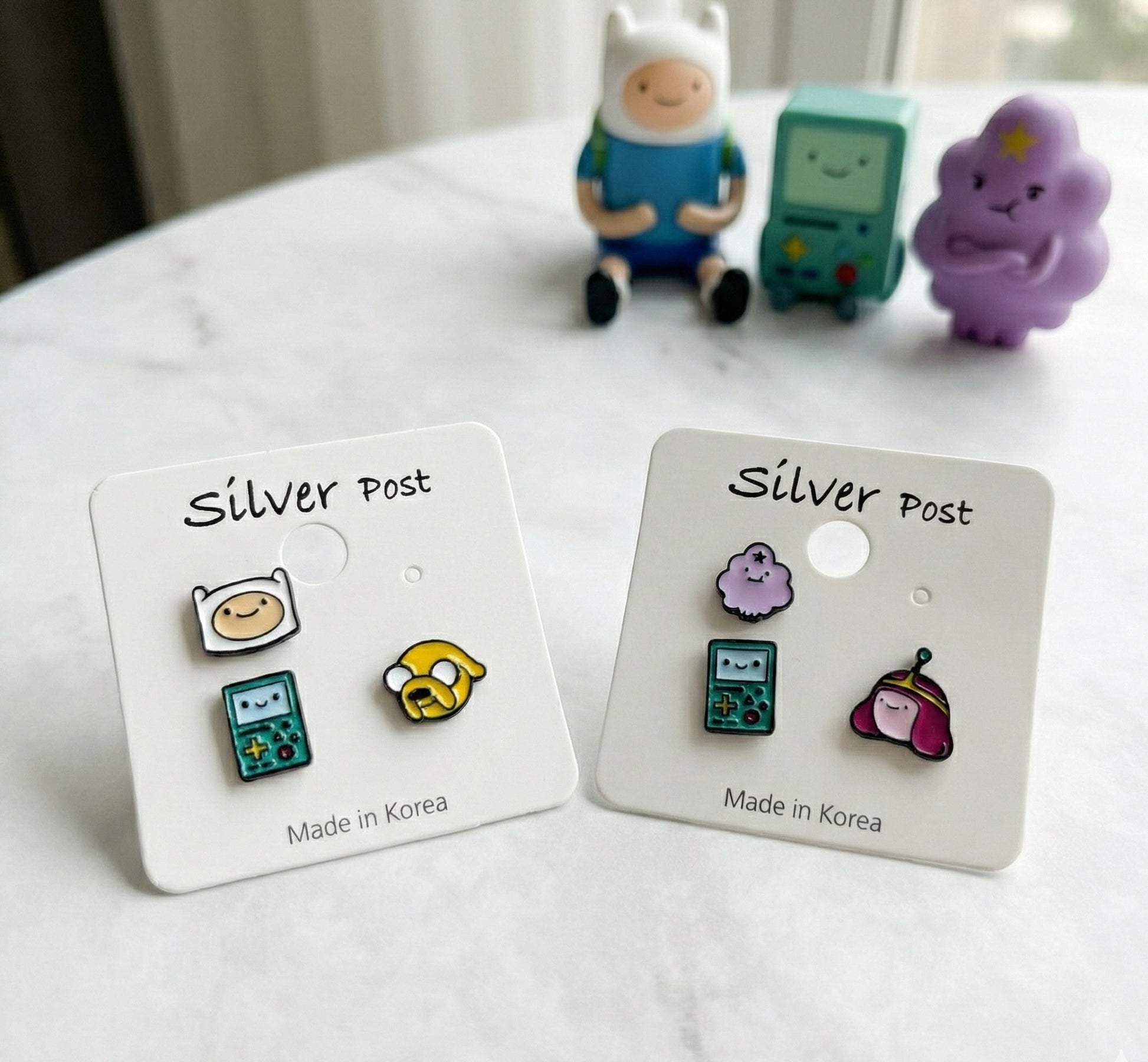 Adventure Time earrings set featuring Finn Jake BMO and LSP Princess Bubblegum on packaging cards with silver post labels