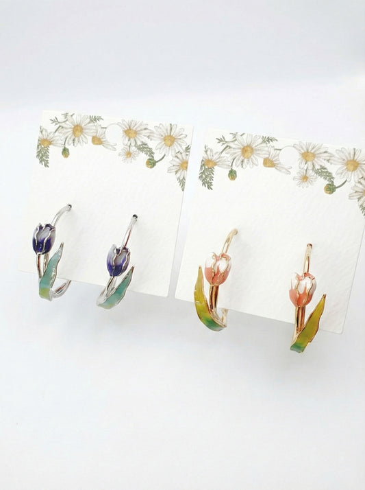 Two pairs of handmade tulip hoop earrings in blue and pink watercolor gradients