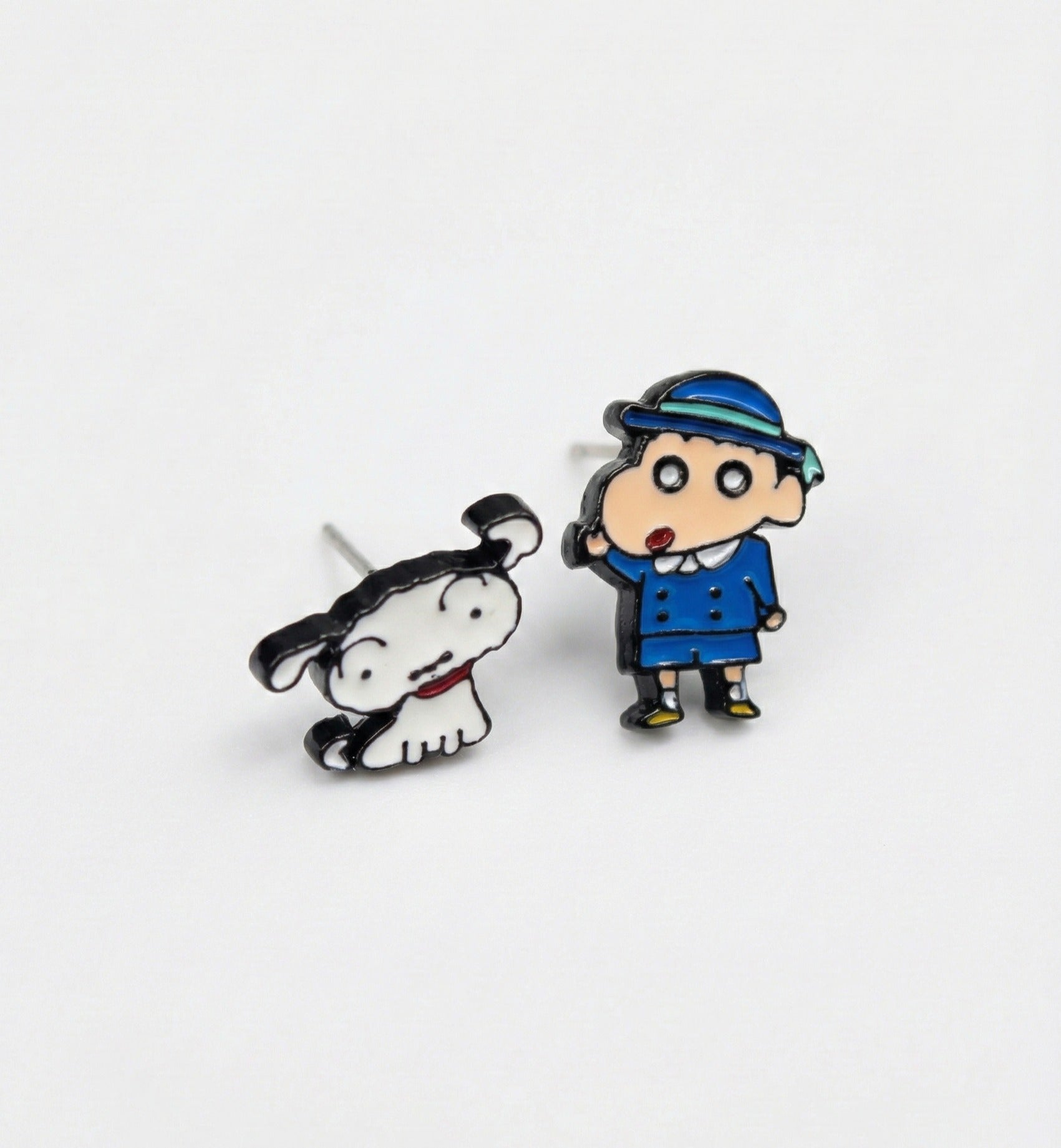 Close-up of Shin-chan in blue school uniform and Shiro dog enamel stud earrings with silver posts on white background