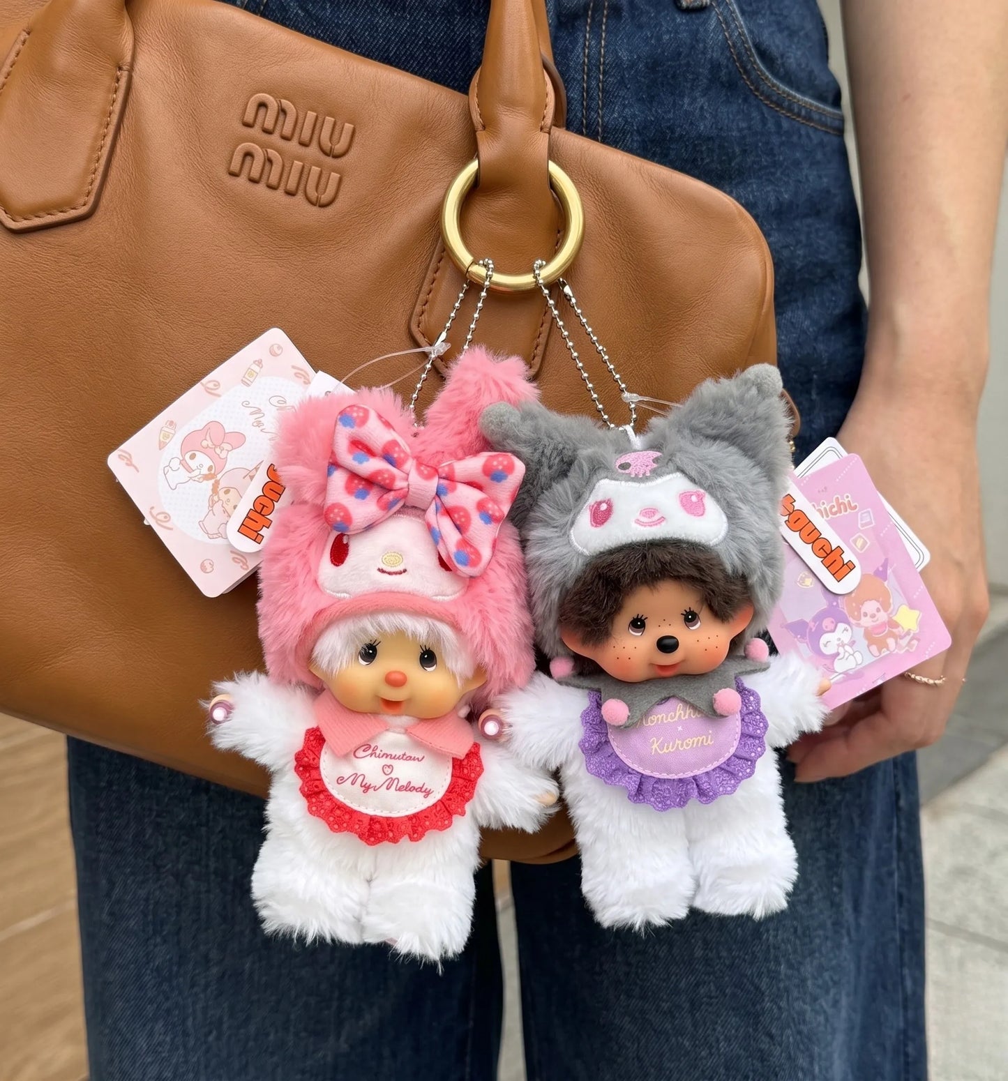 K-style bag charm layering inspo with pink bunny and grunge cat plush keychain clipped on luxury brown leather bag — kawaii aesthetic 8ttitto8