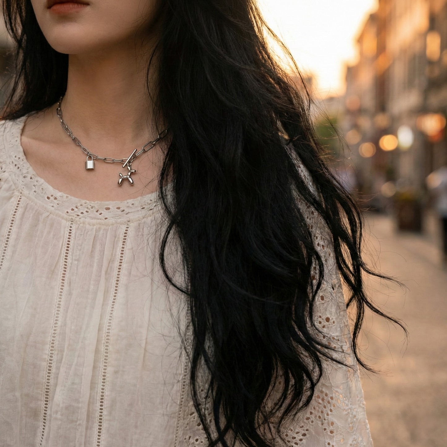  Woman wearing white lace dress with silver chain necklace outdoors at sunset