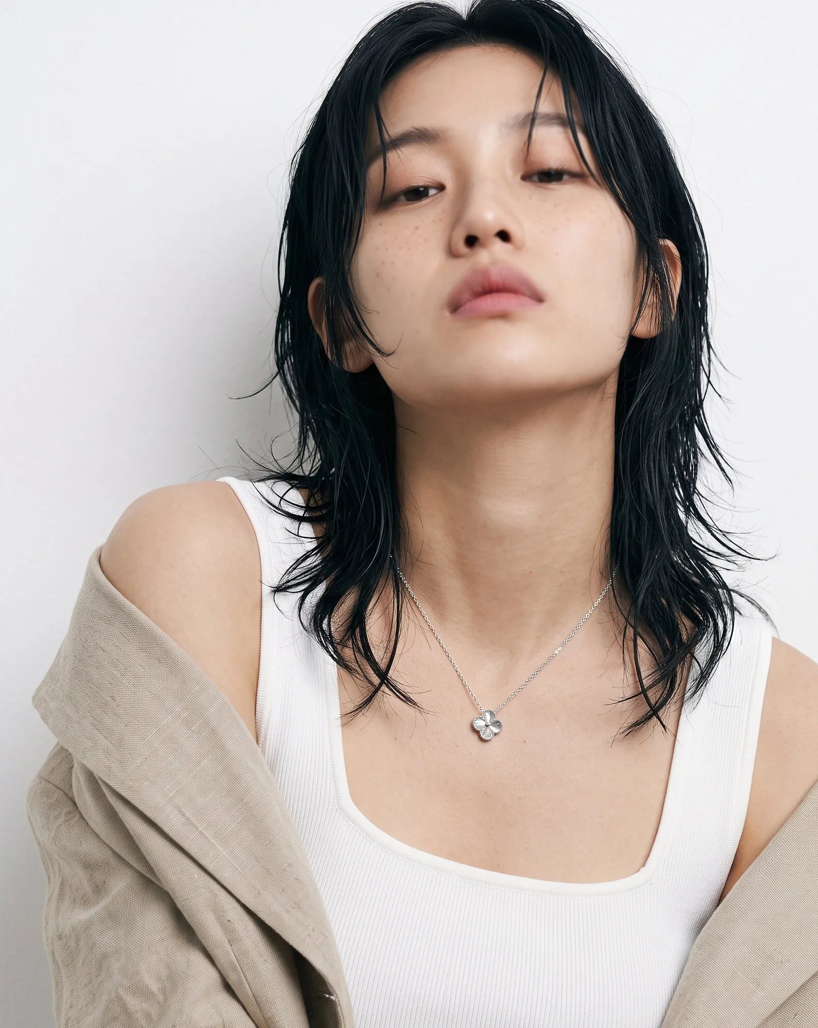 Clean girl aesthetic 925 silver milgrain clover necklace worn with linen jacket white tank top layered cut hair, K-style hypoallergenic daily necklace collarbone look.