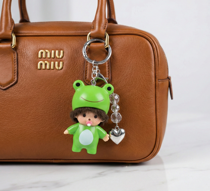 Kawaii frog doll bag charm with crystal beads and silver heart attached to tan Miu Miu leather handbag