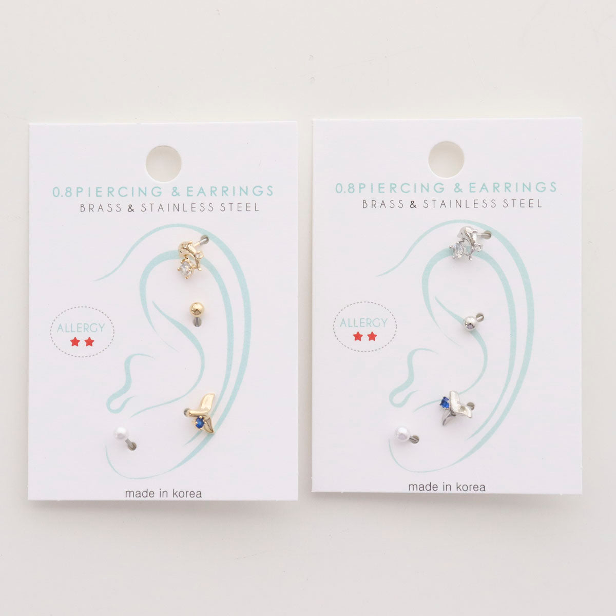 Lucky ocean barbell stud earring set packaging showing gold and silver options with allergy-free label
