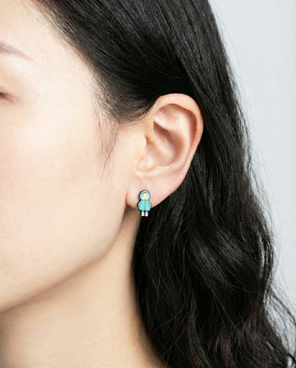 Close-up of blue raincoat Mei character stud earring on model's earlobe