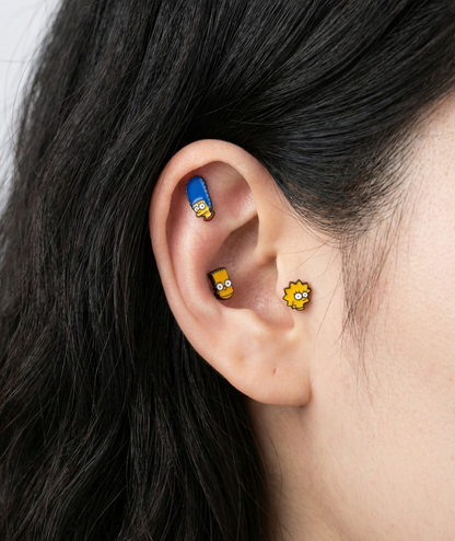 Bart Simpson and Lisa Simpson enamel stud earrings on ear, showing cartilage and lobe placement, Korean handmade jewelry