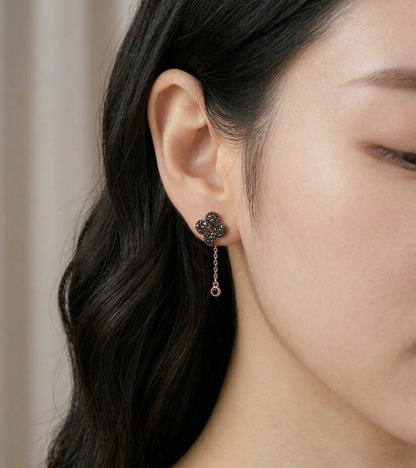 Side profile wearing shot of cognac brown clover two-way drop earring with rose gold chain, minimal styling