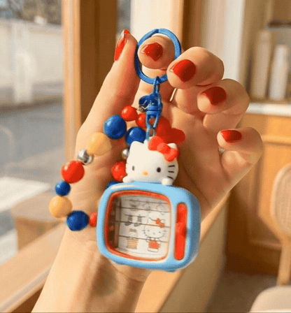  Hand holding genuine Sanrio Hello Kitty retro TV keychain with colorful candy bead chain showing size scale — kawaii Y2K fidget bag charm