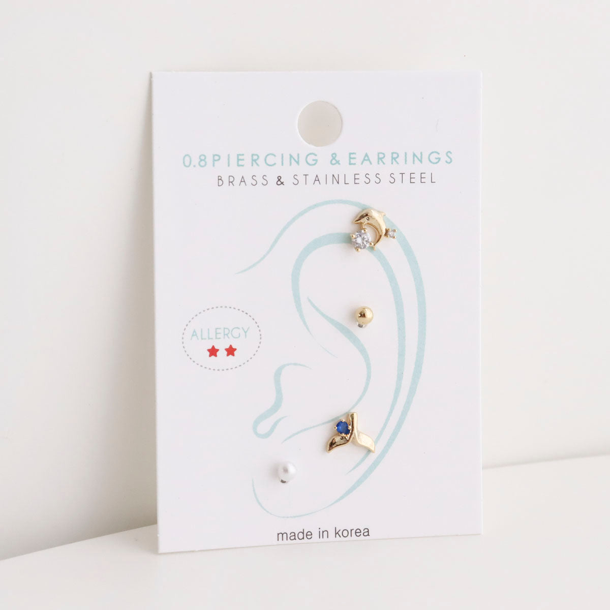  Single card display of 4-piece surgical steel piercing set with ear diagram placement guide 