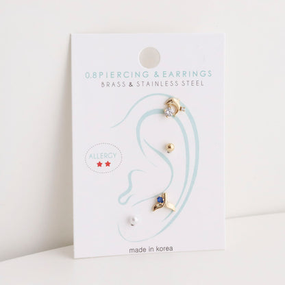  Single card display of 4-piece surgical steel piercing set with ear diagram placement guide 