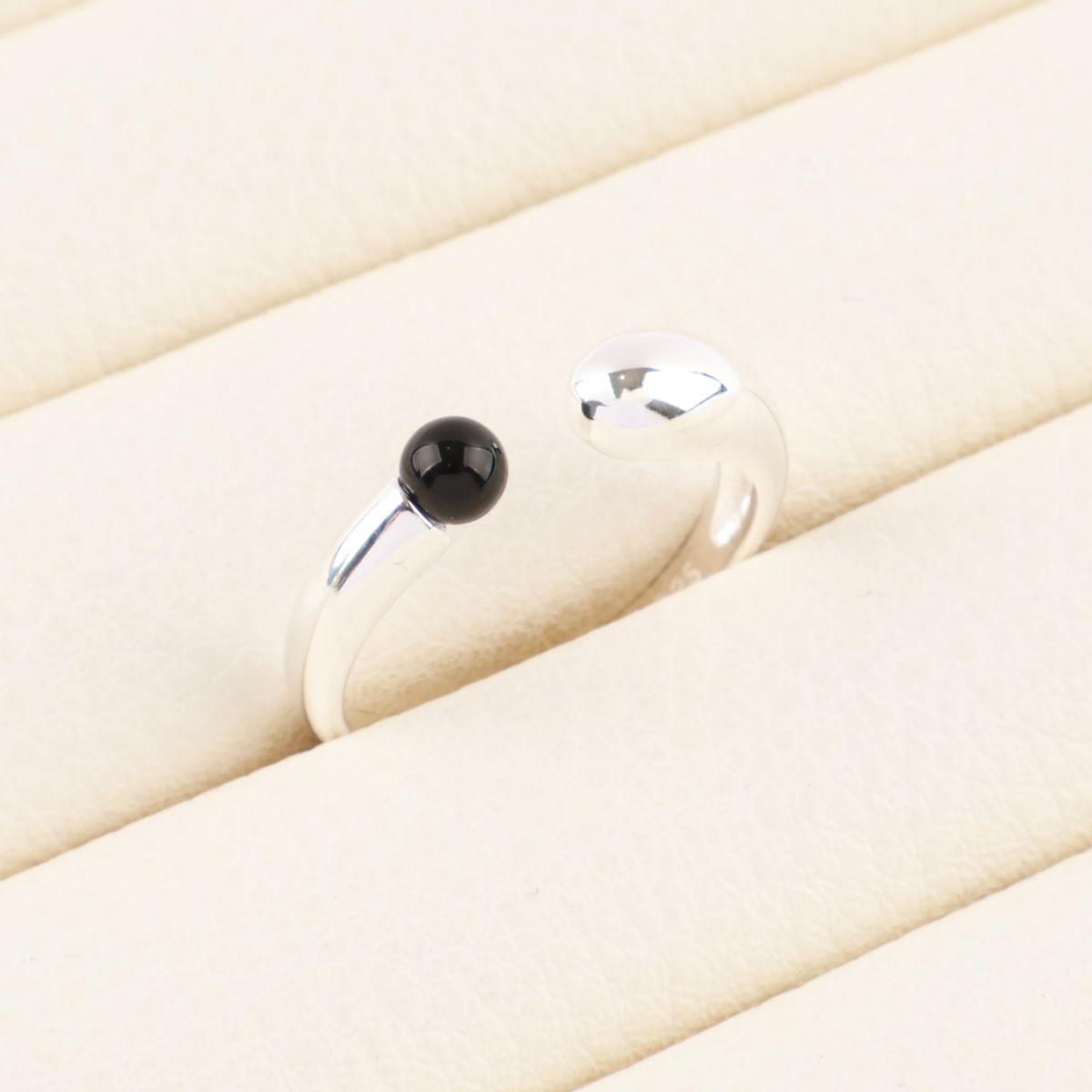  925 sterling silver single black onyx open ring resting on cream velvet jewelry tray — bold minimalist detail shot