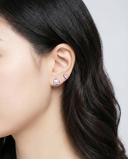 Woman wearing white cat and heart mismatched earrings - cute character stud earrings