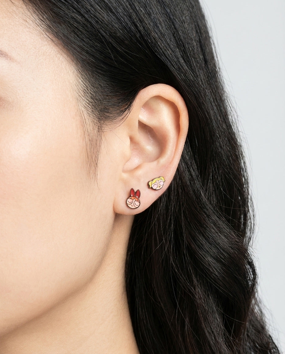 Full ear styling with three Powerpuff Girls barbell studs - layered on lobe outer conch and helix piercings