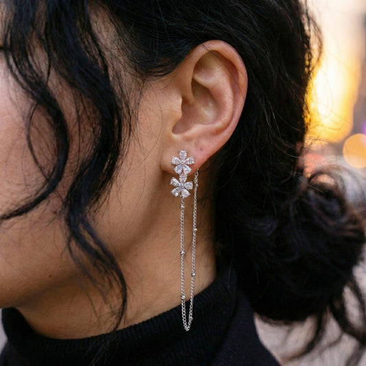 Side view of delicate crystal flower ear jacket with hanging chain detail