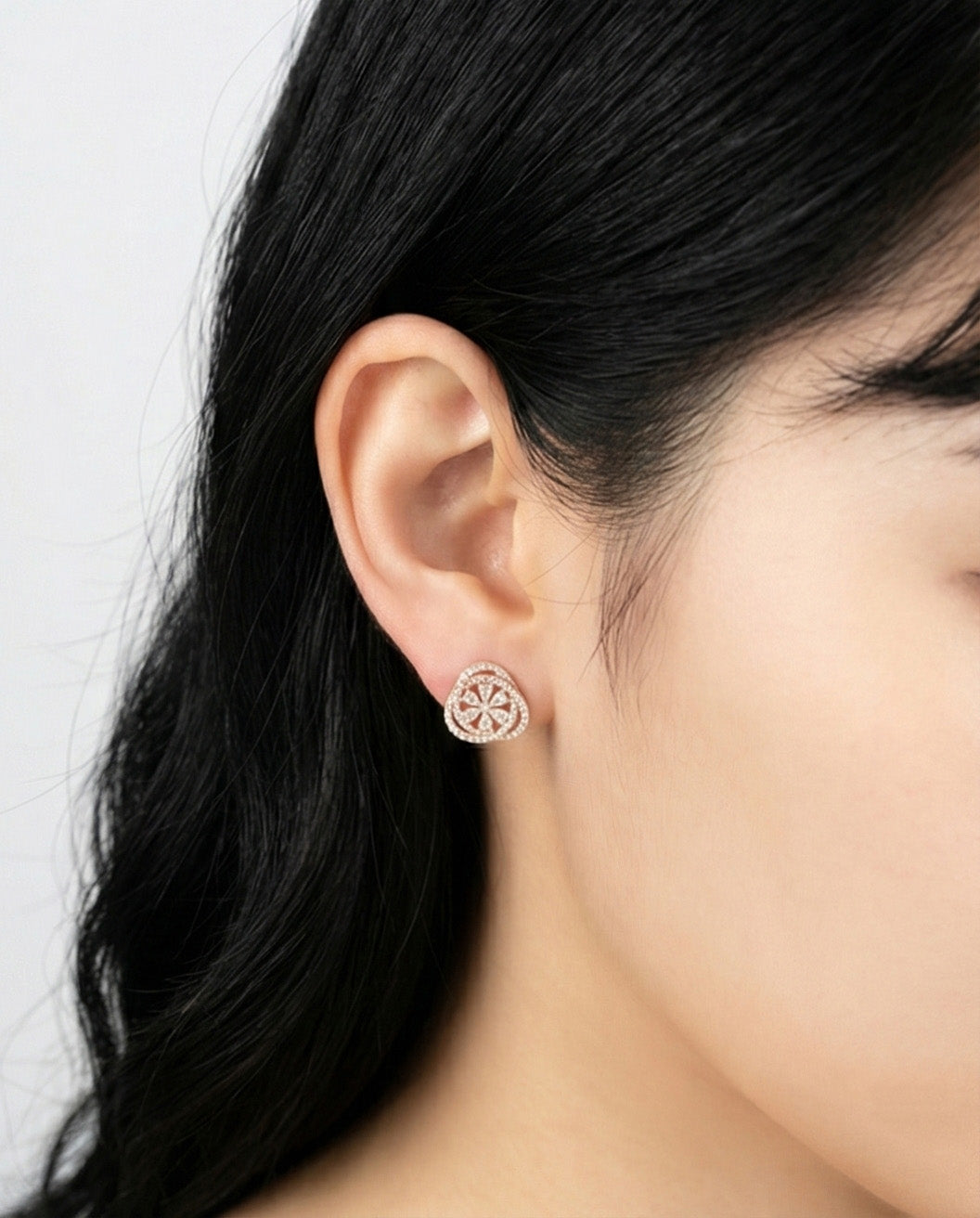 Side view woman wearing rose gold heart CZ earring showing delicate flower center detail, 925 sterling silver hypoallergenic posts, Korean handmade