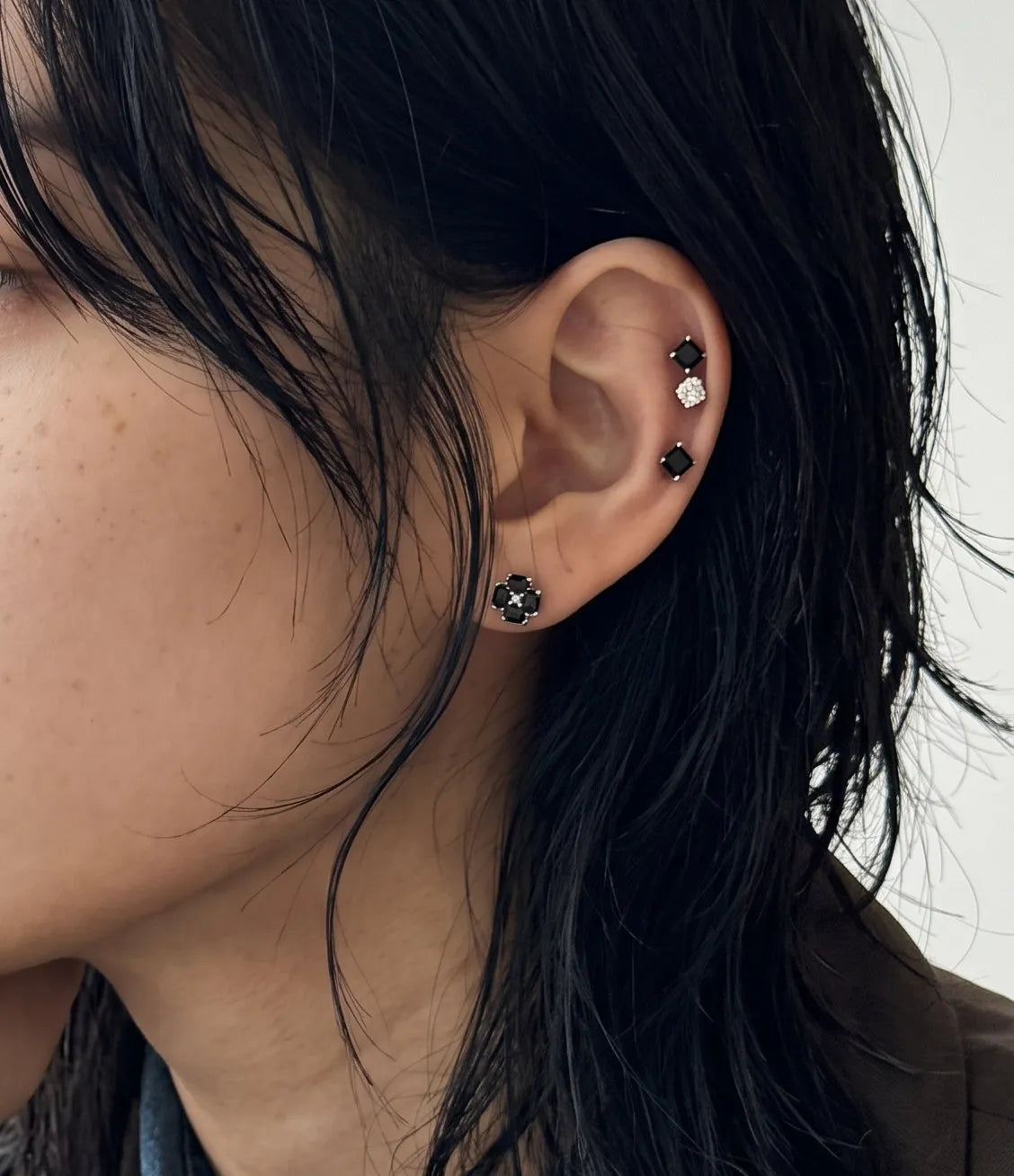 Curated ear stack inspo featuring black clover helix and tragus studs