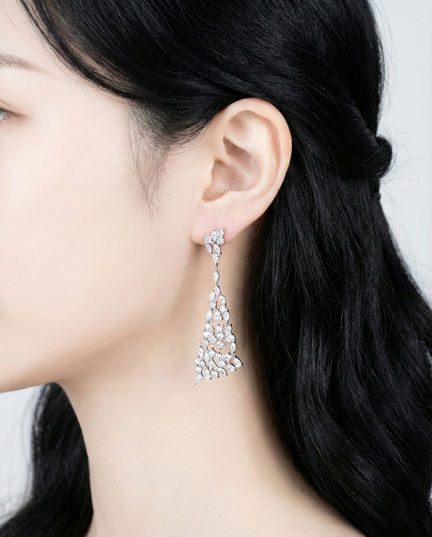 Elegant long drop earrings with marquise cut stones on model