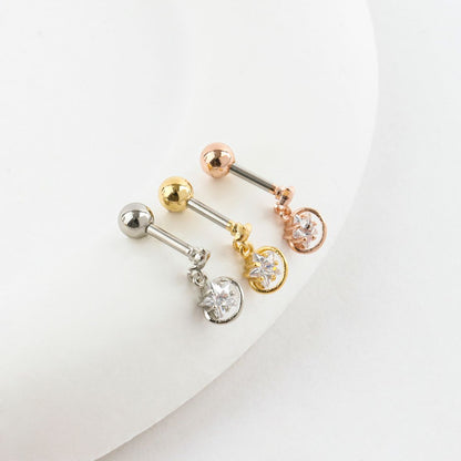 Three dangling star planet barbell earrings in silver, gold, and rose gold with clear cubic zirconia.