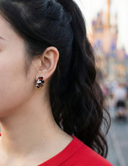 Close-up side view of Minnie Mouse front-back earring showing 3D body hanging behind earlobe