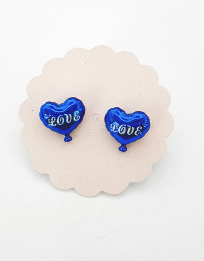 Royal blue heart balloon earrings with silver LOVE lettering on scalloped display