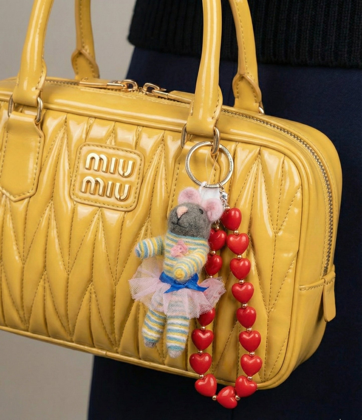Yellow Miu Miu bag styled with striped ballerina mouse keychain and heart bead strap for Y2K aesthetic
